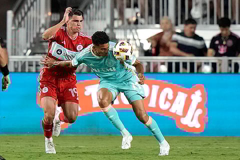 Ian Fray heads the ball as Georgios Koutsias defends